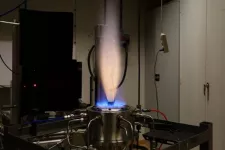 Bright blue bottom gas with a yellow candle like gas going upwards. Photo.