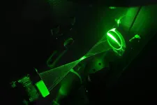 Green overlapping lines with the shape of a hourglass. Picture.